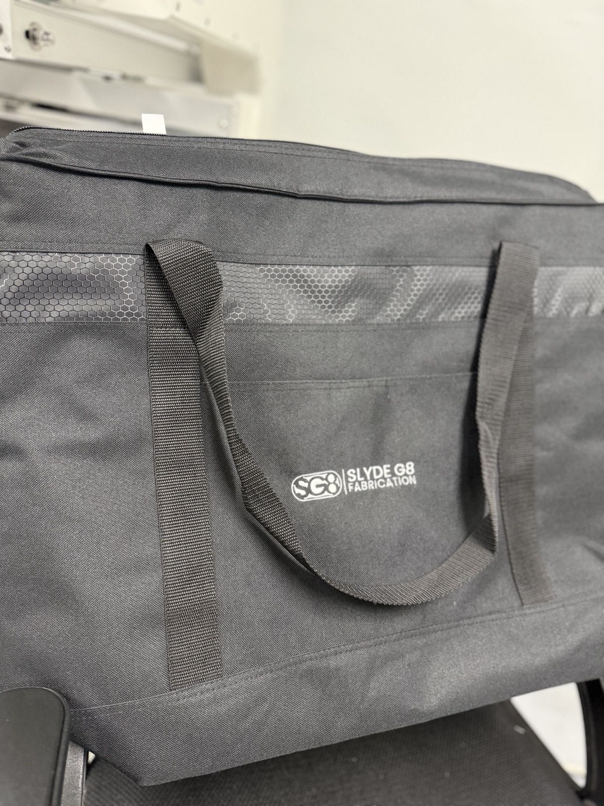 Gray cooler bag branded with a company logo